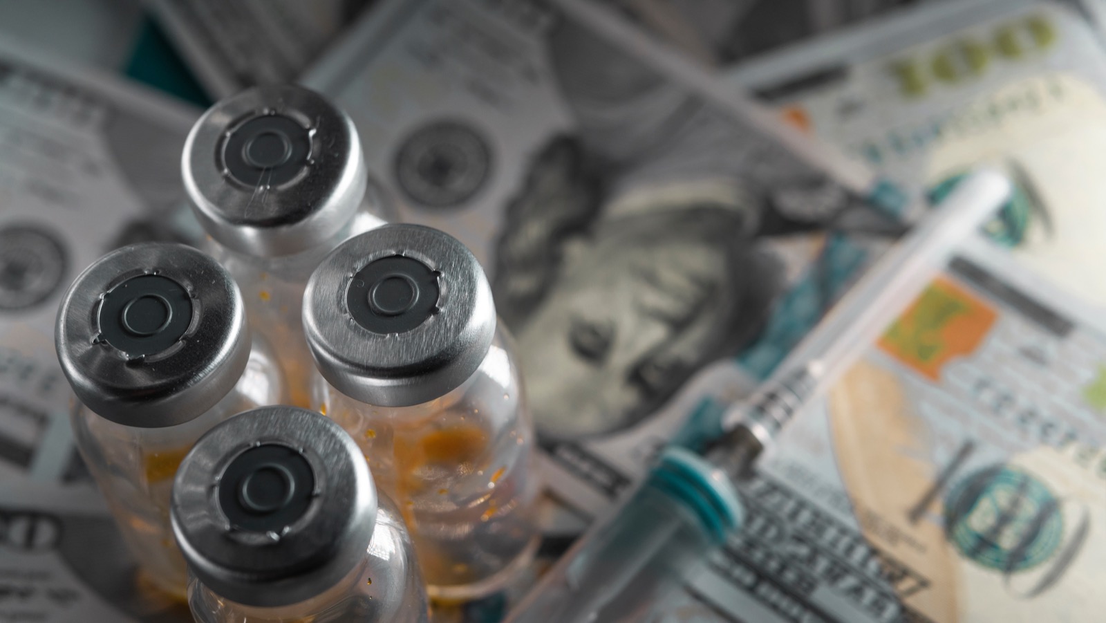 Pharmaceutical vials arranged on top of hundred-dollar bills, illustrating the economics of the gray market
